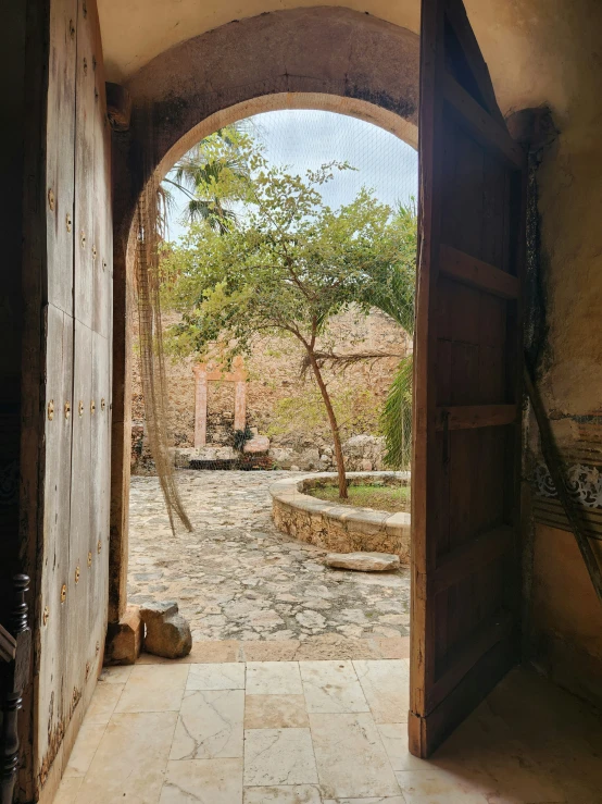 an open door leading to a small stone patio