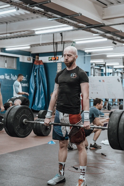 the men are in a gym with their equipment