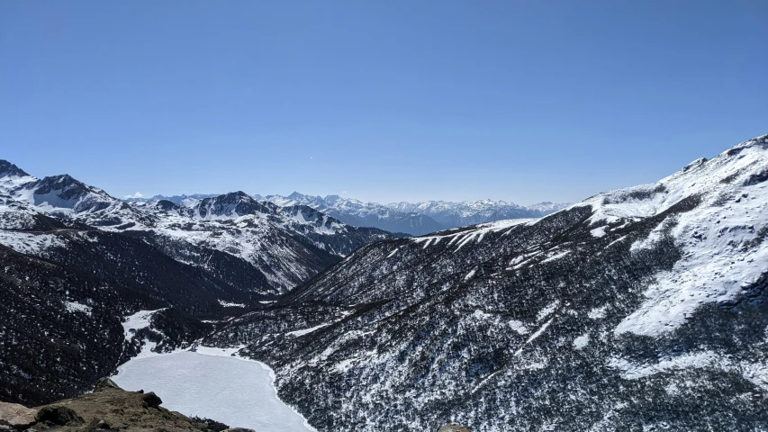 the sky is blue with very little snow on mountains