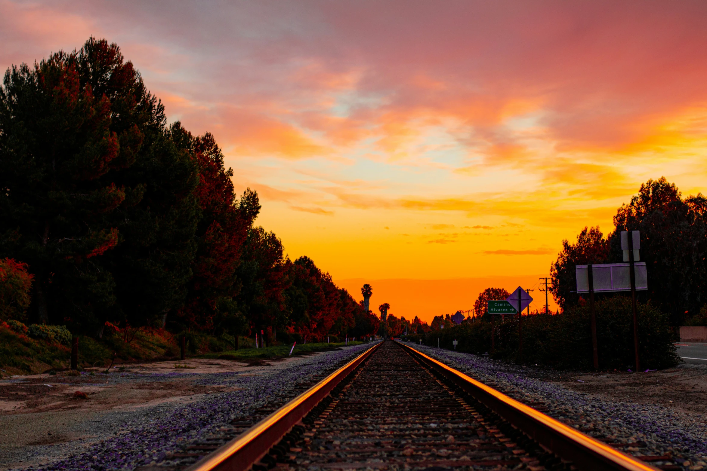 an image of a sunset with train tracks