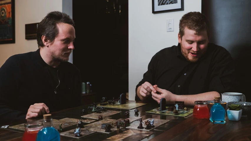 two people play games on the wooden table