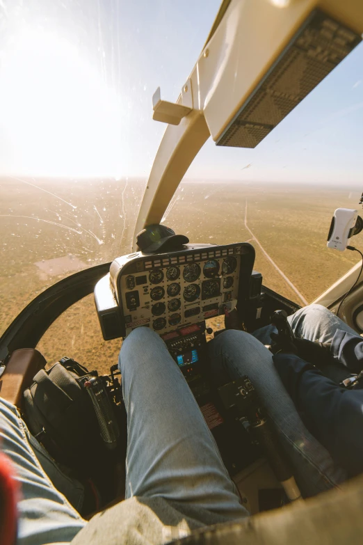 two people sit inside the cockpit of a small airplane