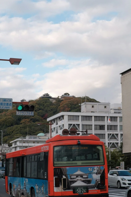 a large bus is traveling down the street in a big city