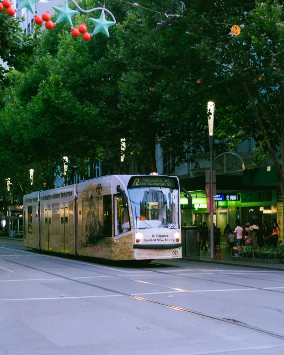 a trolley driving down the street on a cloudy day