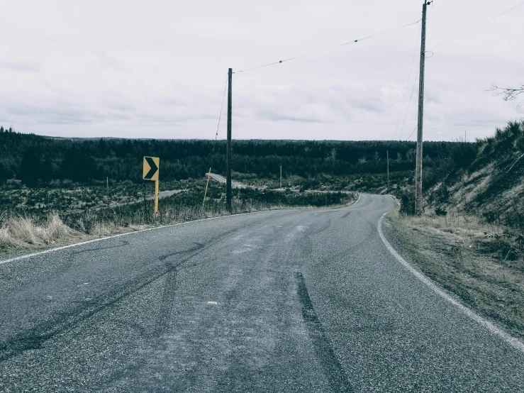 a small road sign sitting on the side of a road