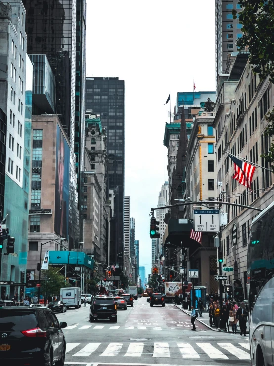 a busy city street filled with traffic surrounded by tall buildings