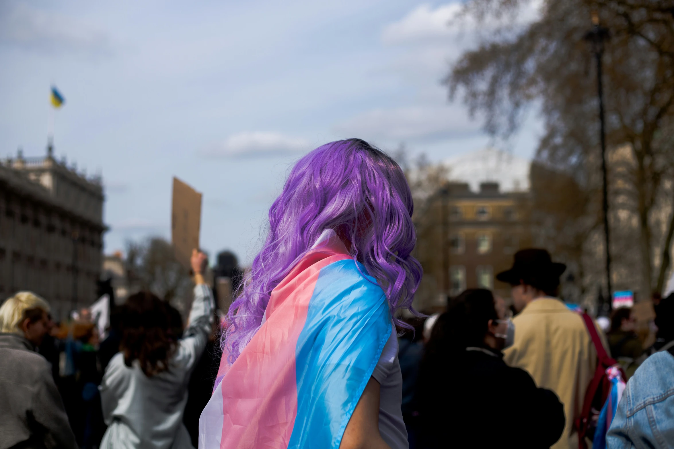 the woman with purple hair is walking with others