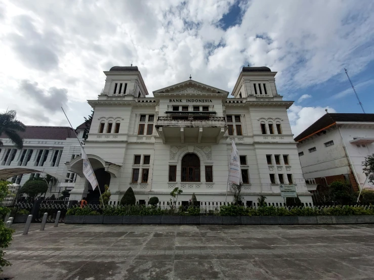 a large white building with many stories on it