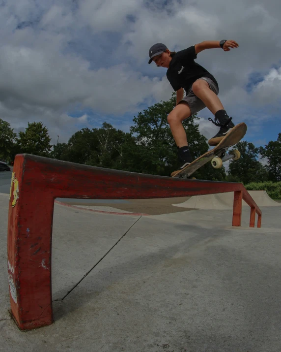 a person that is jumping on a skateboard over the rail