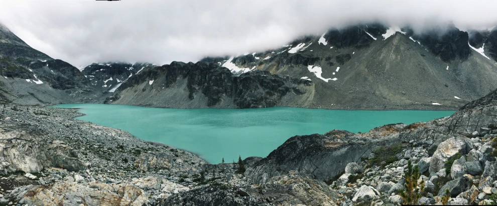 a mountain landscape with some water in the middle