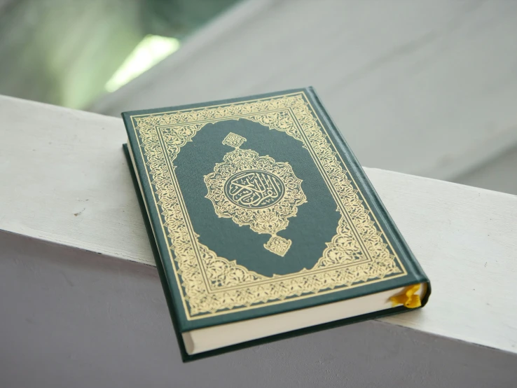 an arabic textbook sitting on a ledge