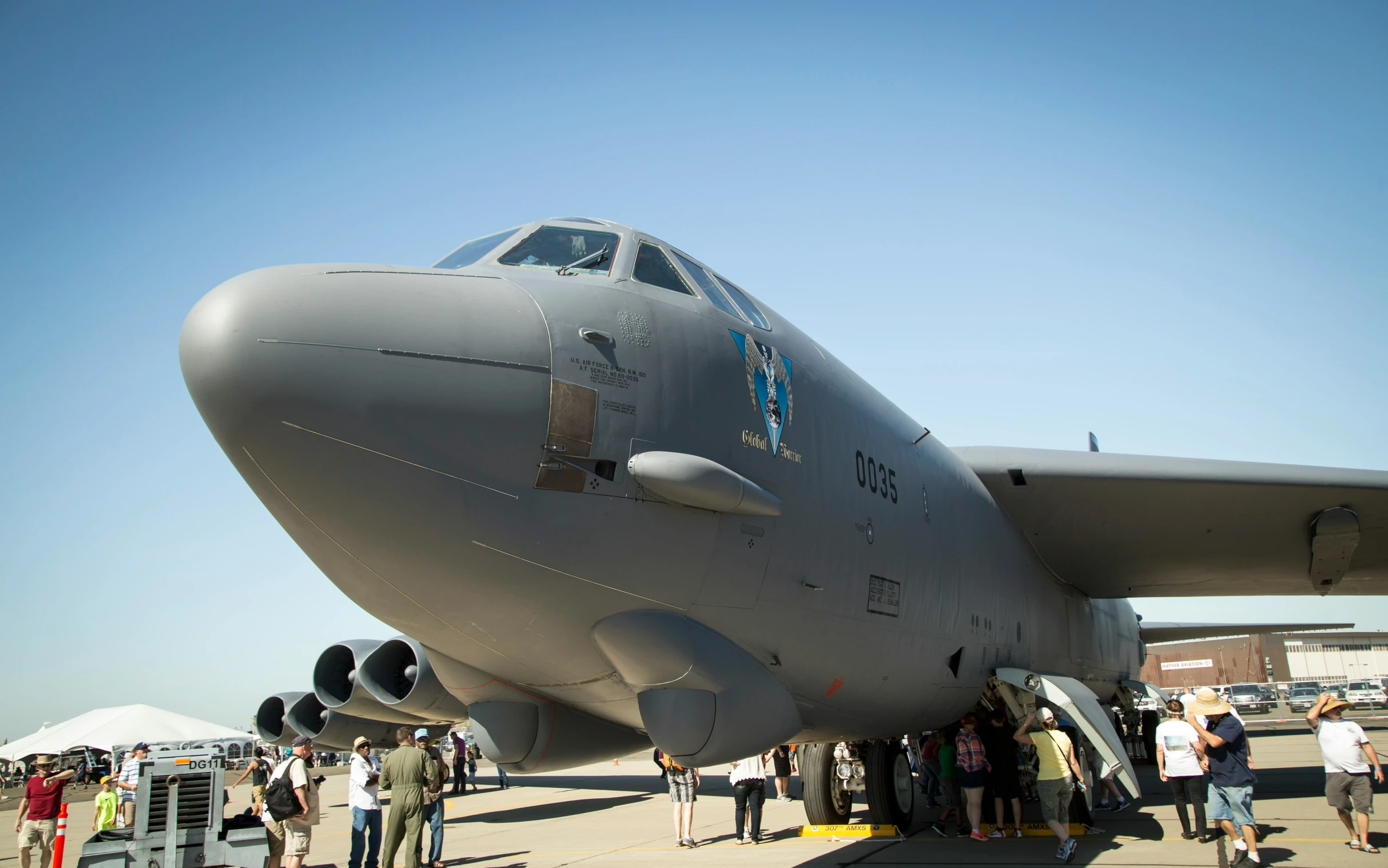 large air plane parked near many people