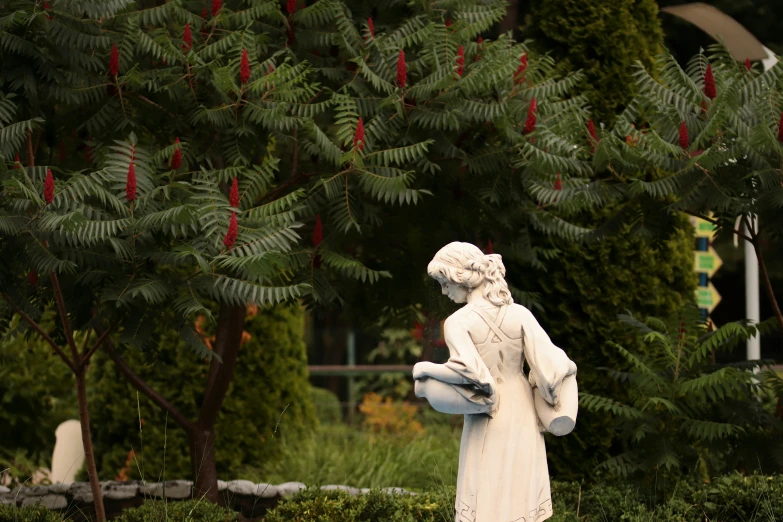 a statue of a person in the woods