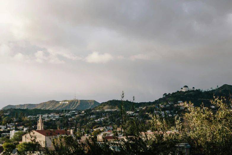 a town in the distance from the mountains on a cloudy day