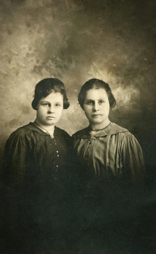 two women standing side by side in an old po