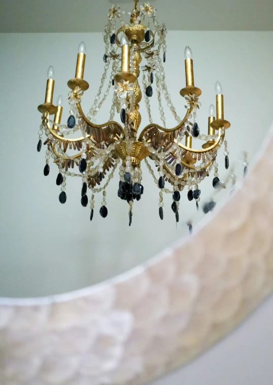 a fancy chandelier hangs from a ceiling in an otherwise empty room