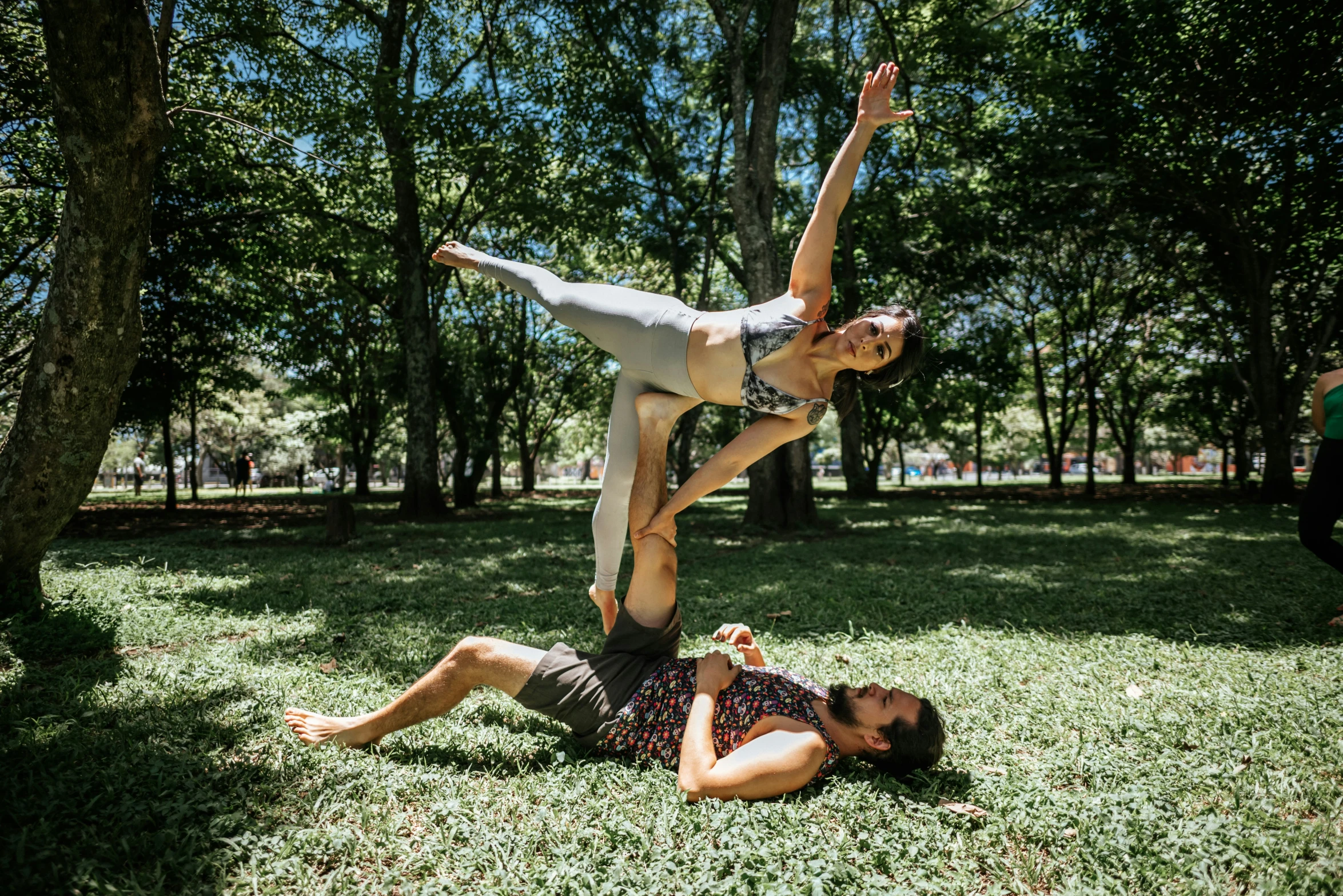 two people are doing the splits in the park