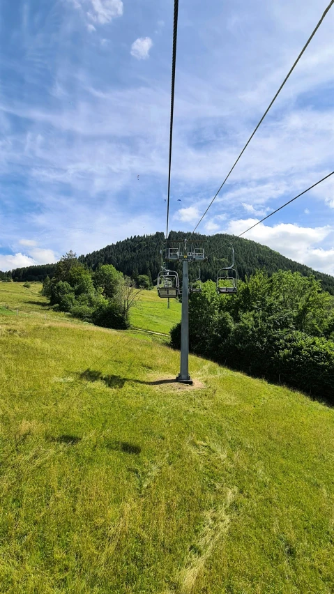 a chairlift riding up to the top of a hill