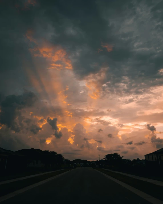 a sunset view from the side of a highway