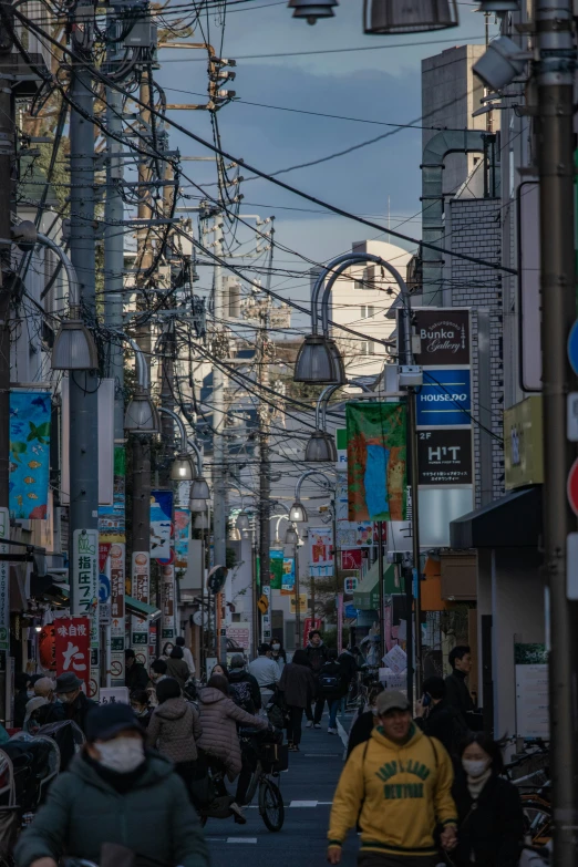 a group of people on scooters ride down a street