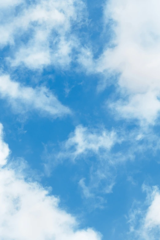 the view of a plane flying high in the blue sky