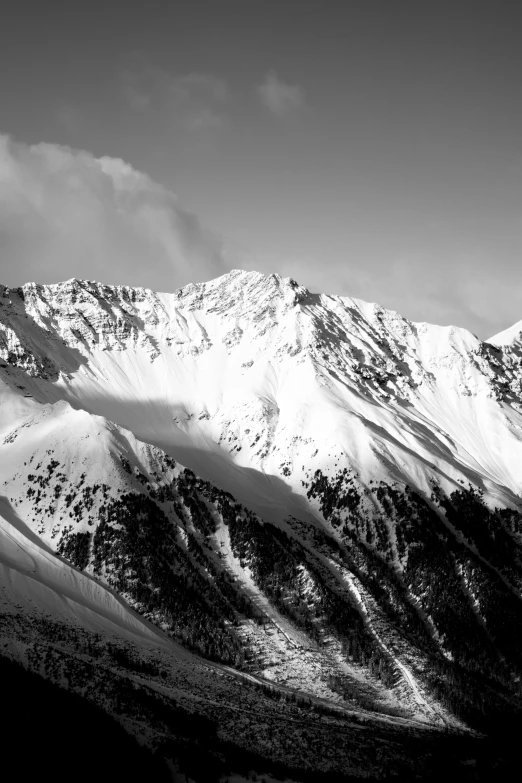 a ski lodge with two skiers standing in front of the mountain range