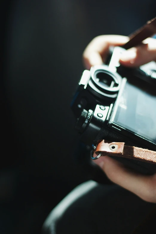 a woman is holding a camera in her hand