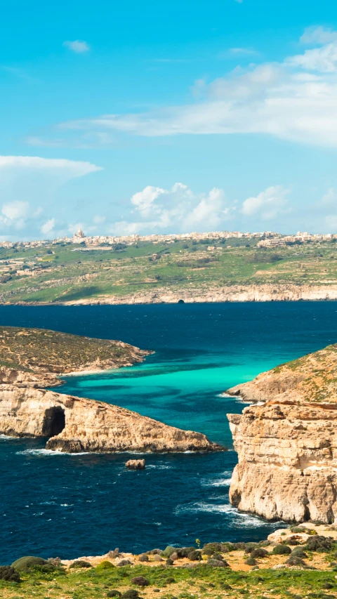 the beach is near a very steep cliff face