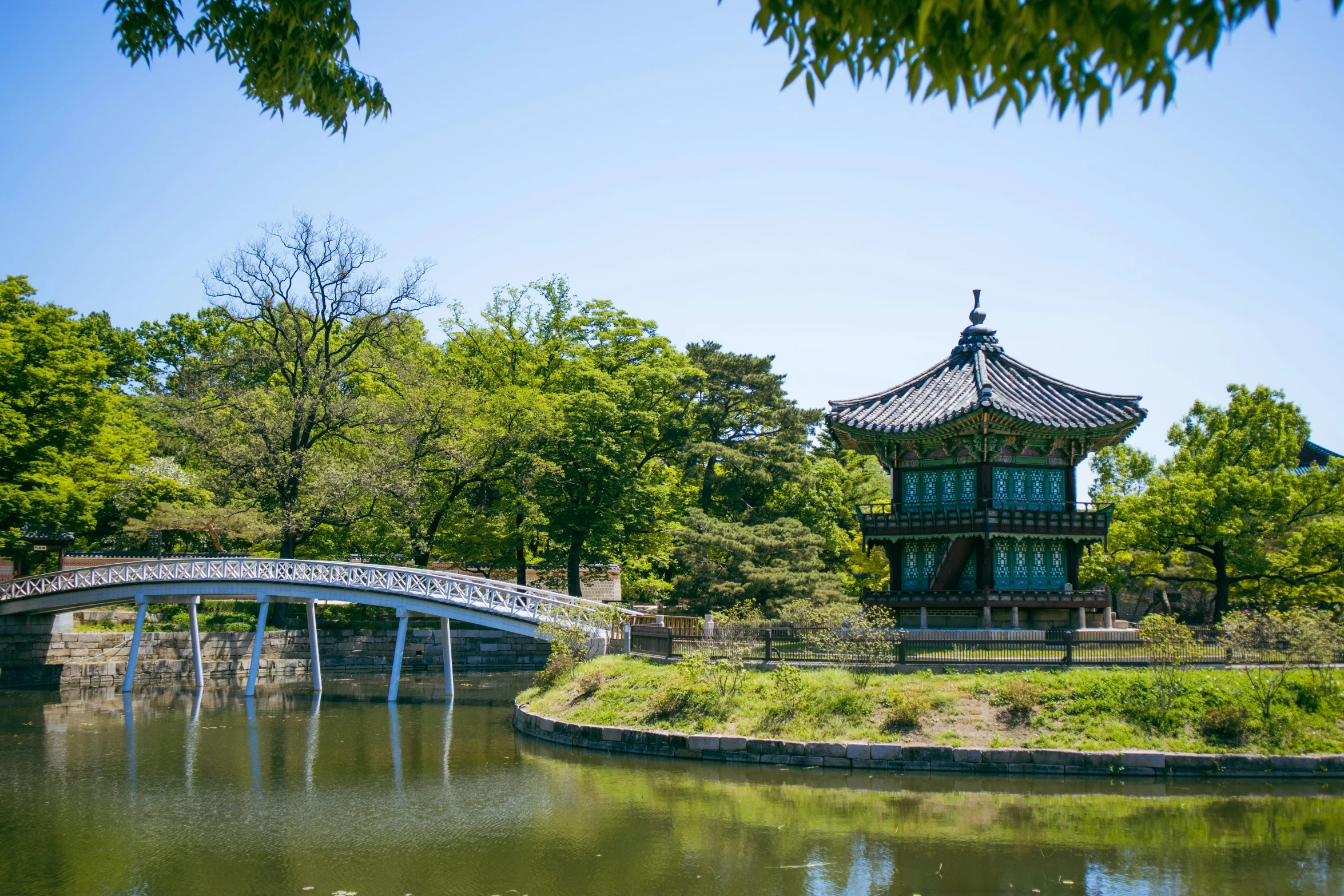 a bridge over a body of water near a building