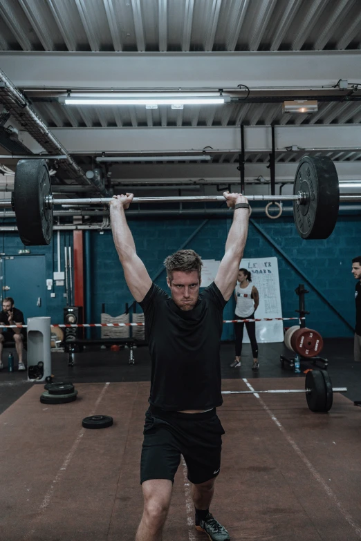 a man is lifting some heavy weights in a gym