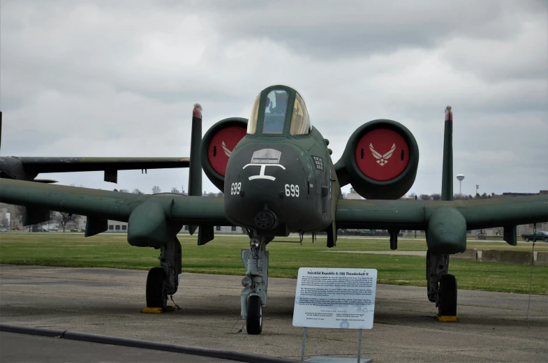 the fighter jet is sitting on the ground by itself