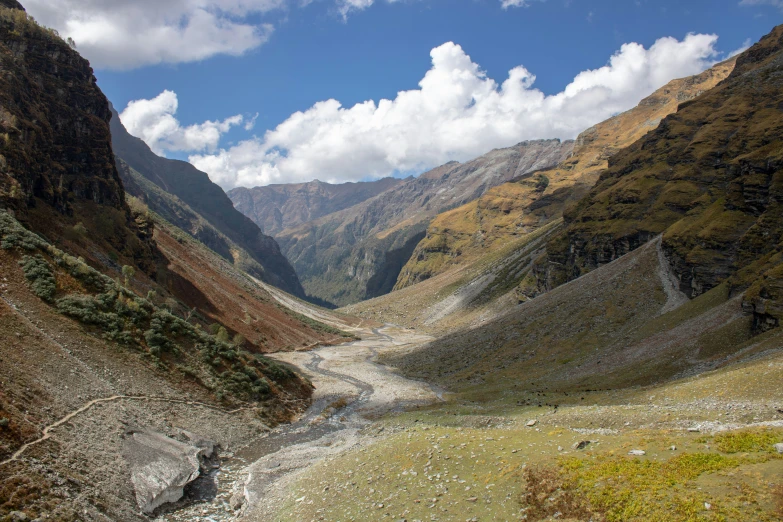 a long winding road cuts through an arid canyon