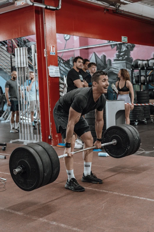 man performing a competition in the gym with barbell squats