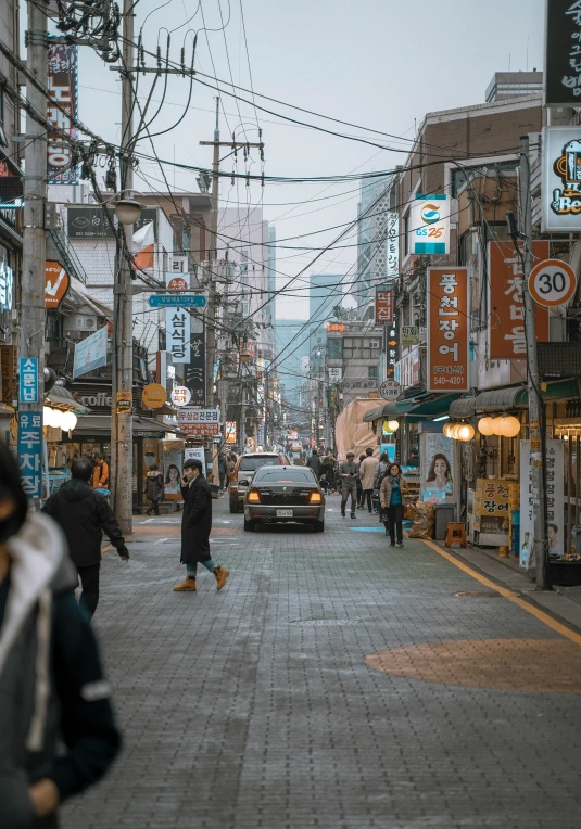 a couple of people walking down a city street