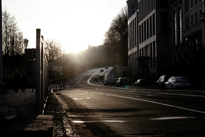 a sun is shining down on a city street