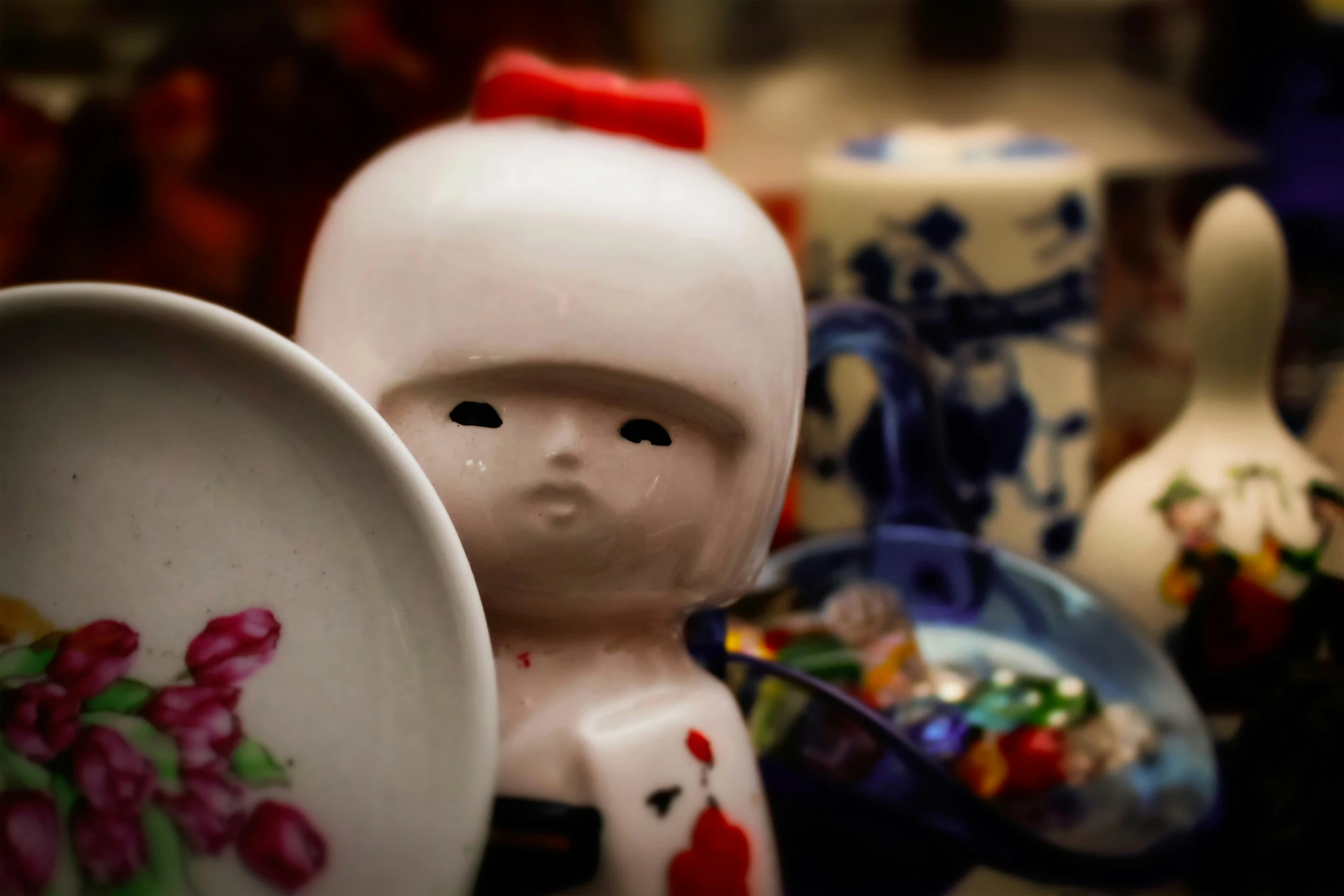 a close up view of a ceramic toy next to other pottery pieces