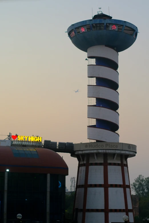 a clock tower is next to an airport sign