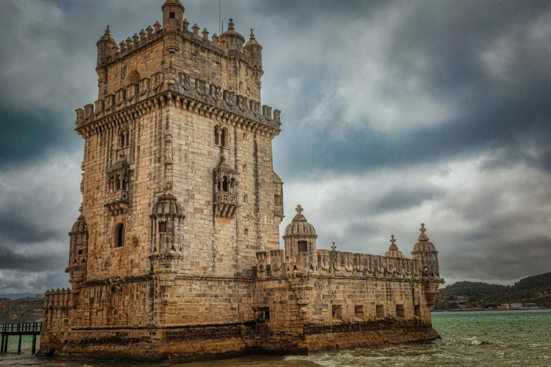 a tall tower with clocks sitting next to a body of water