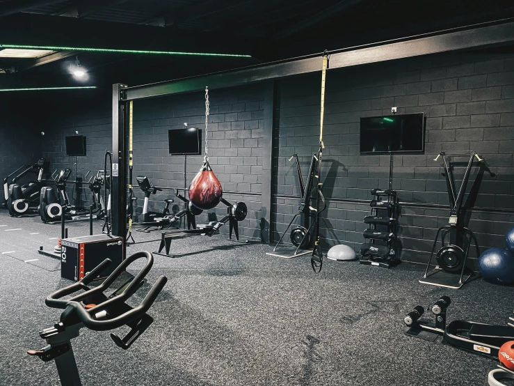 a gym room with machines, exercise balls and other equipment