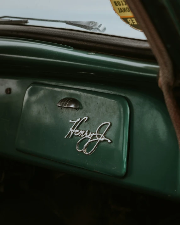 an older car with a vintage sticker on the windshield