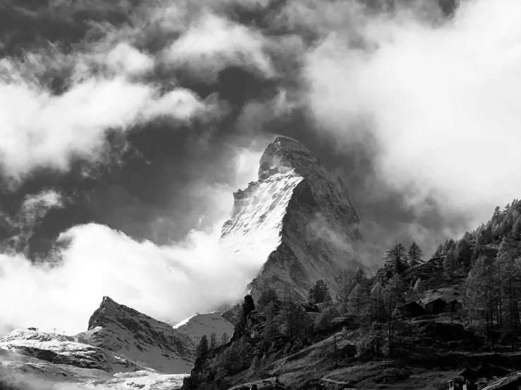 black and white pograph of a mountain peak in cloudy weather