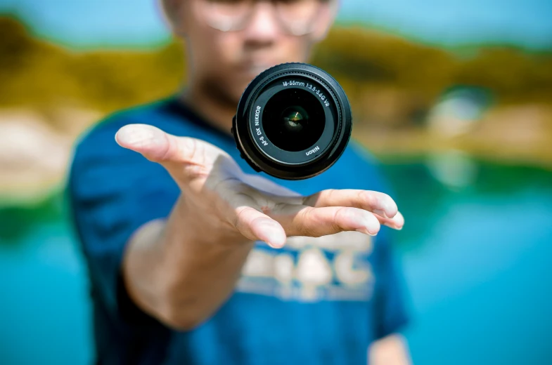 a man is holding a camera in front of him