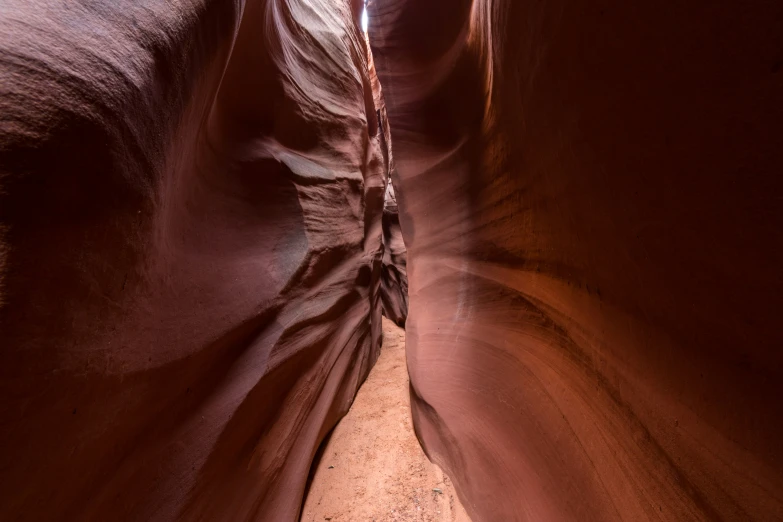 a narrow passageway between two large, wavy cliffs