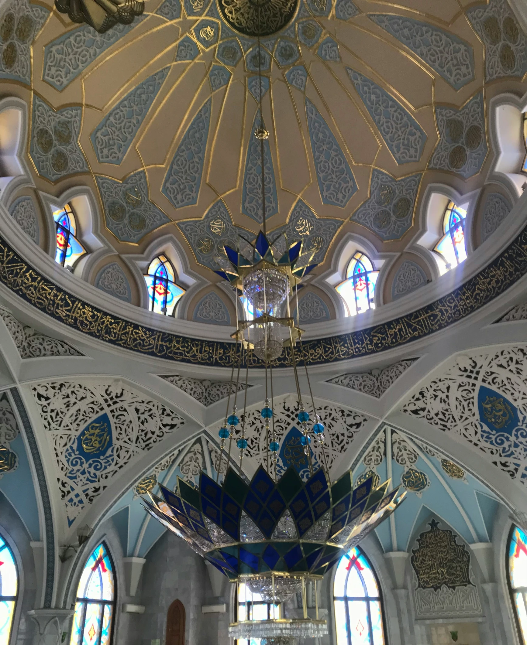 a beautiful ornate ceiling with stained glass windows and blue skylights