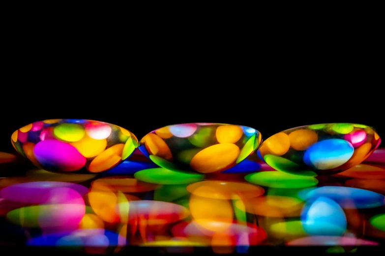 four brightly colored balloons next to each other