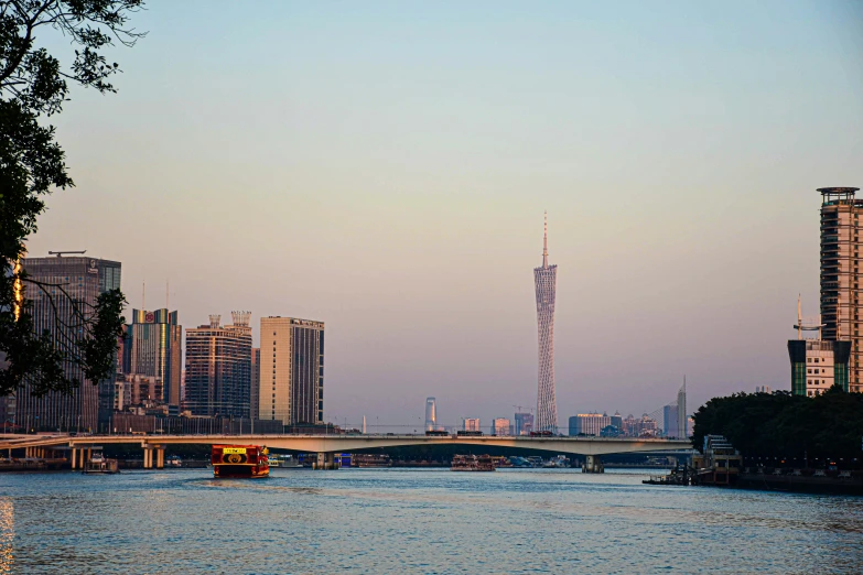 the river runs through a city next to tall buildings