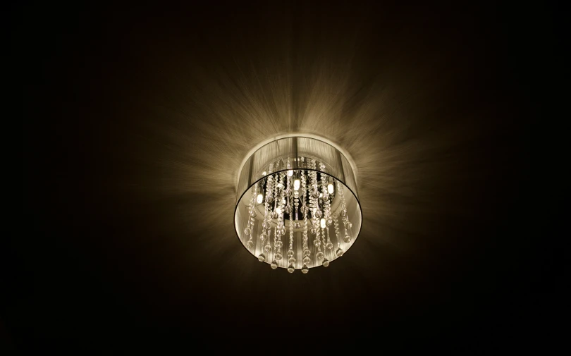 an image of a chandelier hanging in the dark