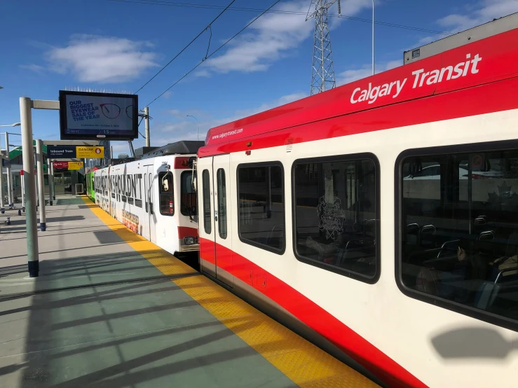 the red and white subway train has stopped at the station