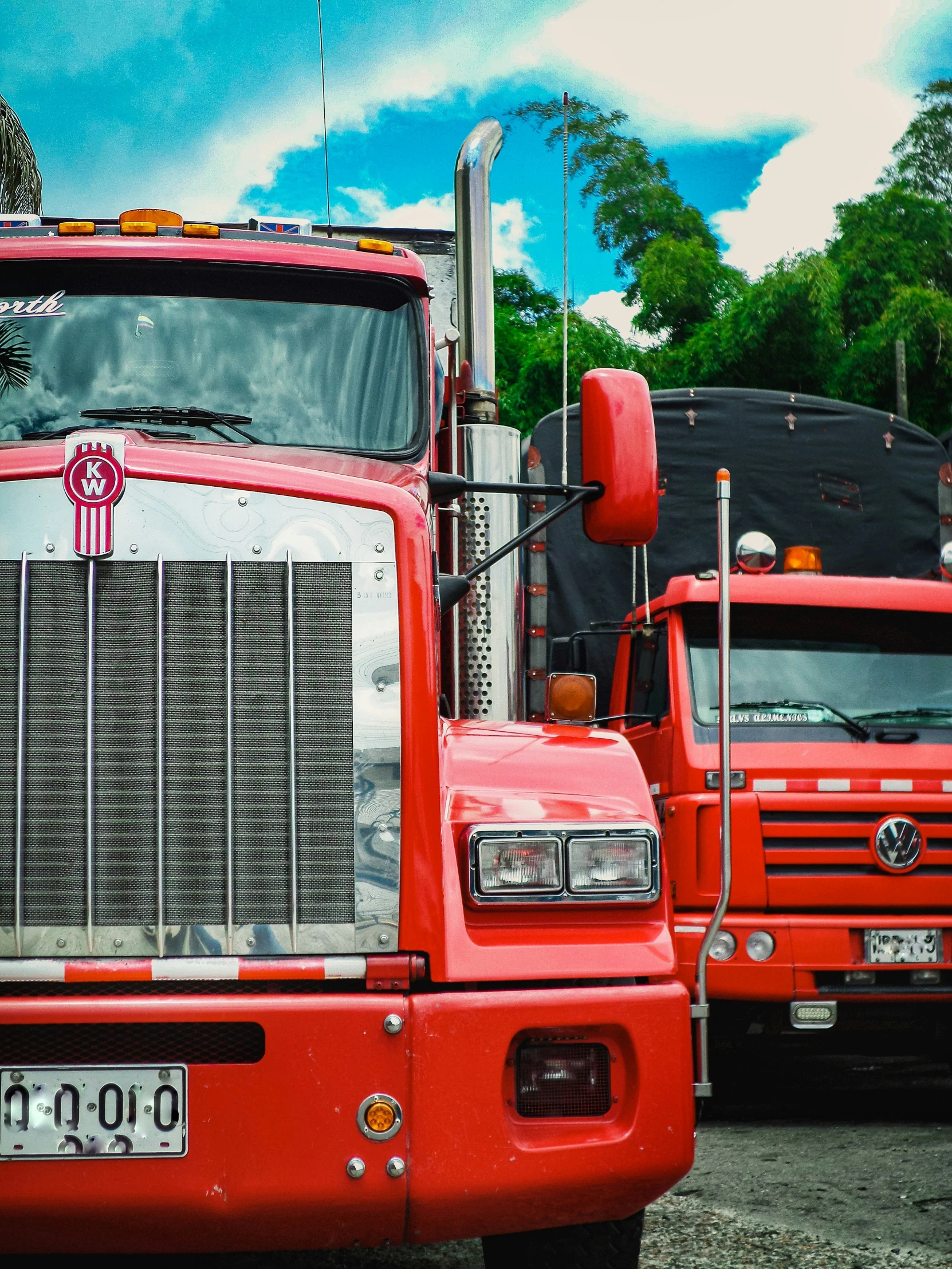 two red trucks parked in a parking lot