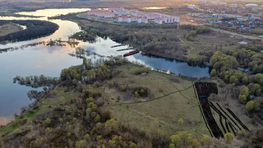 aerial view over a river and grassy land